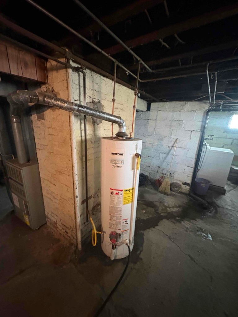 Before photo of an older water heater installation prior to replacement